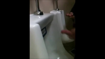 two slim dicks getting wanked at the urinals